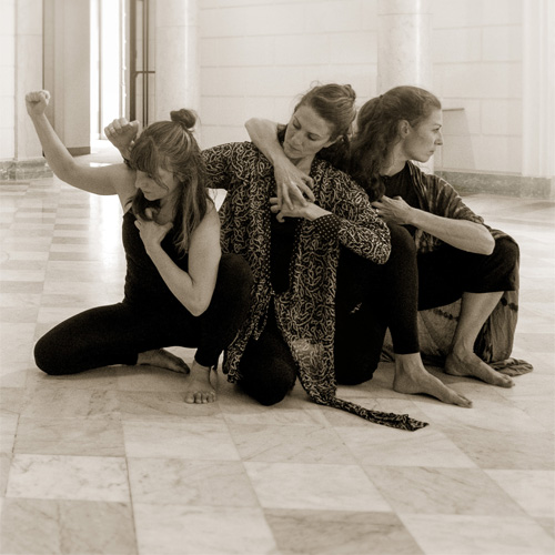 3 women dancing together on the floor